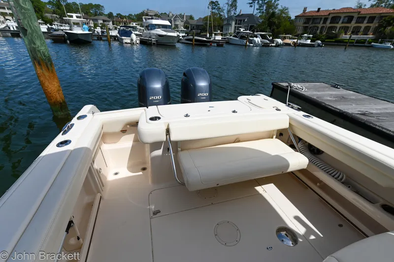 Slide: The Image of 2019 Grady-White Freedom 275 boat with dual engines docked at a marina. - 27
