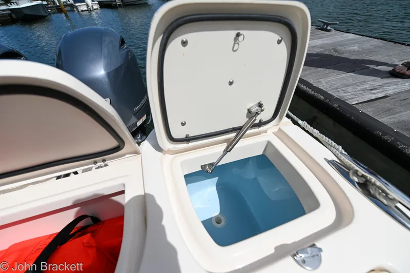 Slide: The Image of Open storage compartment on 2019 Grady-White Freedom 275 boat by the dock. - 30