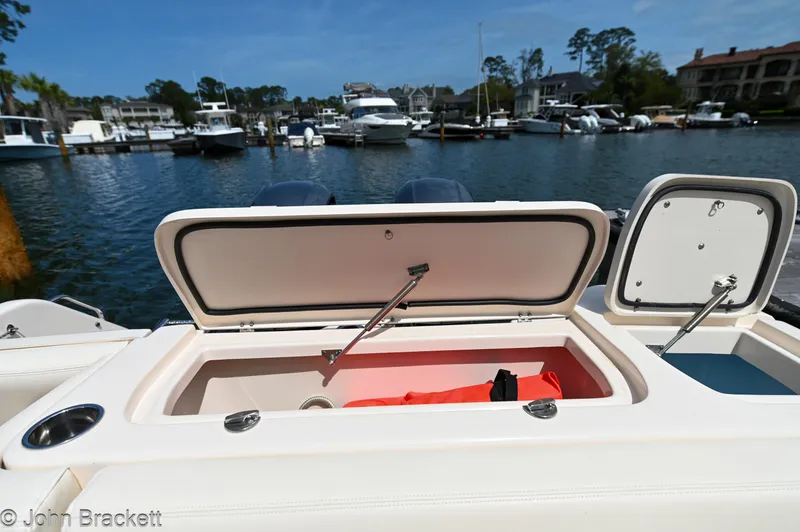 Slide: The Image of 2019 Grady-White Freedom 275 boat with open storage compartment at marina. - 31
