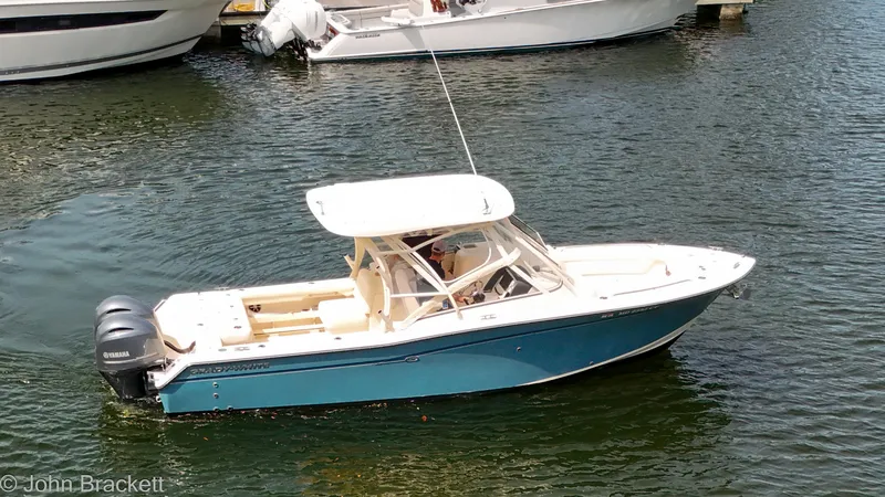 Slide: The Image of 2019 Grady-White Freedom 275 boat on water, featuring sleek design and Yamaha engines. - 37