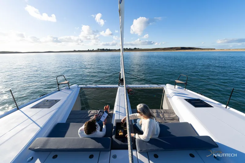 Slide: The Image of 2025 Nautitech 48 Open catamaran on serene water, featuring spacious deck and scenic views. - 20
