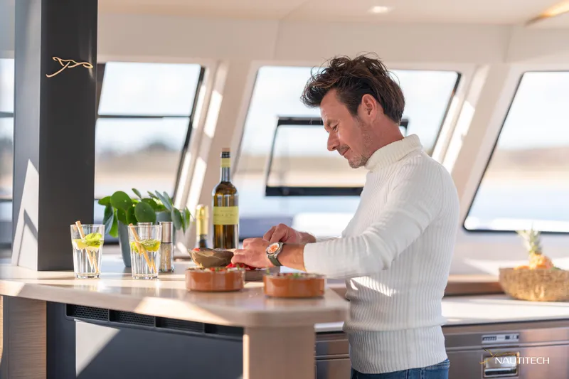 Slide: The Image of Man preparing food in Nautitech 48 Open yacht kitchen, 2025 model. - 41