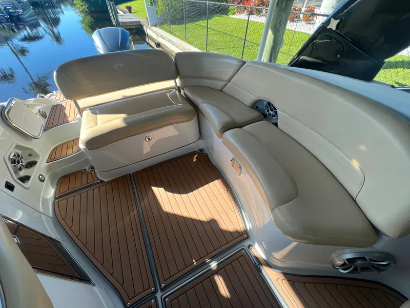 Slide: The Image of 2018 Crownline E26 XS boat interior with beige seating and teak flooring. - 15