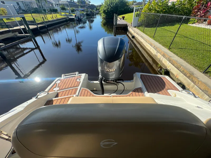 Slide: The Image of 2018 Crownline E26 XS boat with outboard motor on a calm canal. - 19