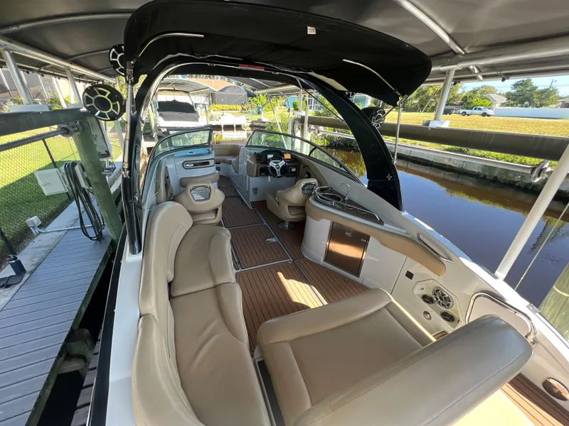 Slide: The Image of 2018 Crownline E26 XS boat interior with beige seating and sleek design. - 3