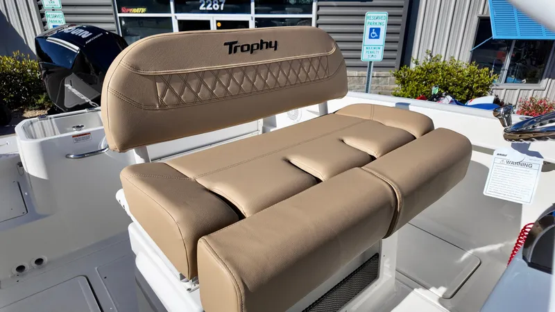 Slide: The Image of 2025 Bayliner Trophy 24 CC boat with tan cushioned seating. - 11