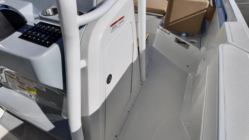 Slide: The Image of 2025 Bayliner Trophy 24 CC boat interior with console and seating area. - 13