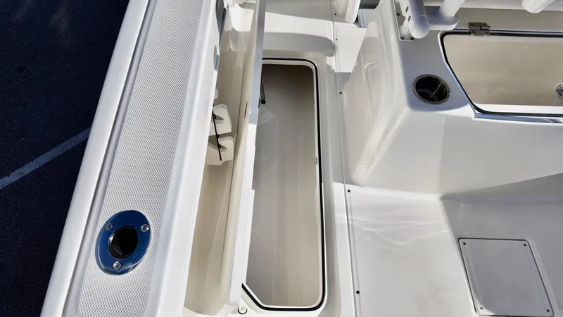 Slide: The Image of 2025 Bayliner Trophy 24 CC boat interior with storage compartment and seating area. - 14