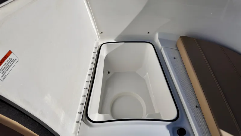 Slide: The Image of 2025 Bayliner Trophy 24 CC boat storage compartment with seating area. - 17