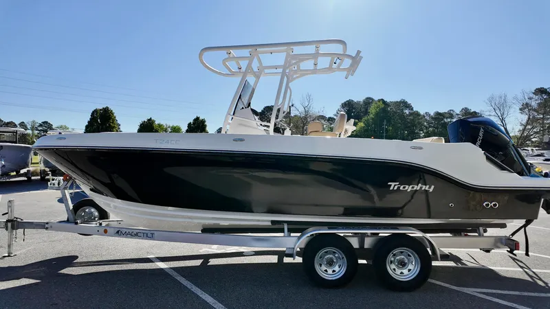 Slide: The Image of 2025 Bayliner Trophy 24 CC boat on trailer, side view, sunny day. - 3