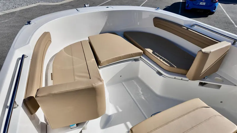 Slide: The Image of 2025 Bayliner Trophy 24 CC boat interior with beige seating and spacious layout. - 6