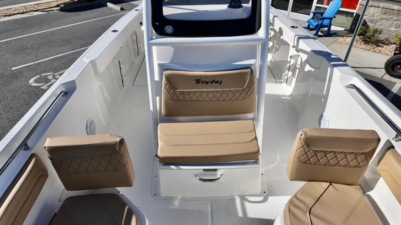 Slide: The Image of 2025 Bayliner Trophy 24 CC boat interior with beige seating and modern design. - 7