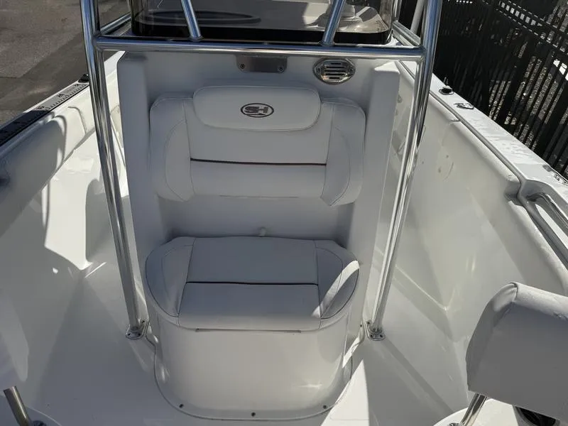 Slide: The Image of 2019 Sea Hunt Ultra 211 boat interior with white cushioned seating. - 10