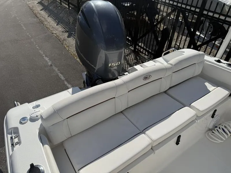 Slide: The Image of 2019 Sea Hunt Ultra 211 boat with Yamaha 150 engine, featuring comfortable seating. - 12