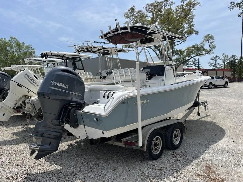 Slide: The Image of 2019 Sea Hunt Ultra 211 boat with Yamaha engine on a trailer in a lot. - 2