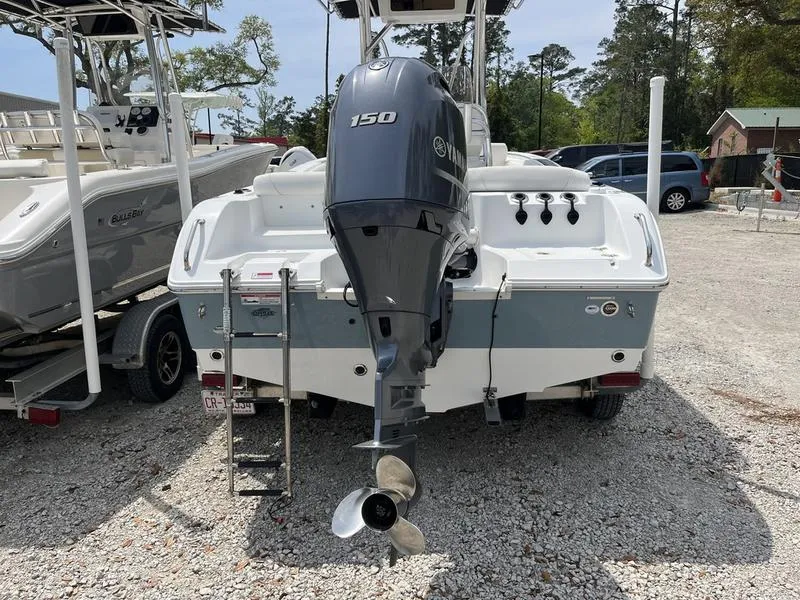 Slide: The Image of 2019 Sea Hunt Ultra 211 boat with Yamaha 150 engine, parked on gravel. - 3