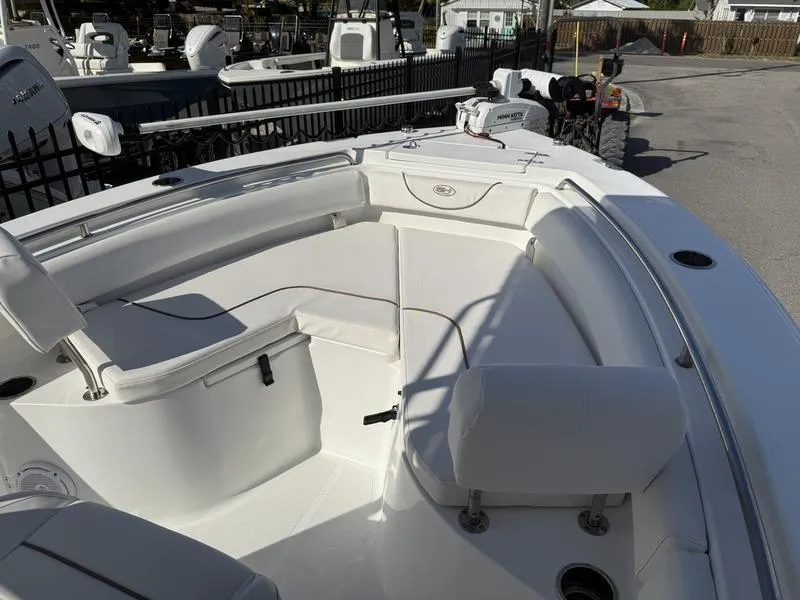 Slide: The Image of 2019 Sea Hunt Ultra 211 boat interior with white seating and storage compartments. - 4