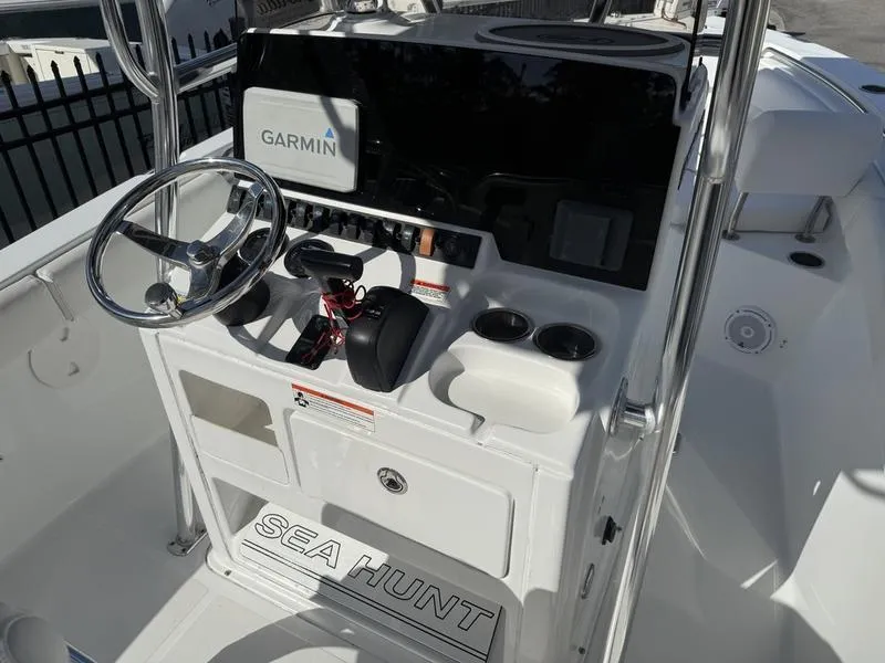 Slide: The Image of 2019 Sea Hunt Ultra 211 boat console with Garmin navigation system and steering wheel. - 6