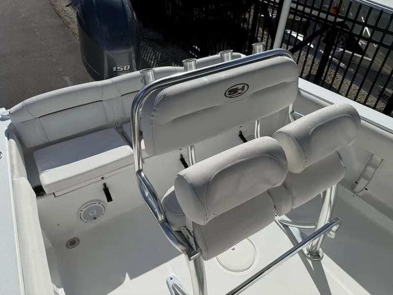 Slide: The Image of 2019 Sea Hunt Ultra 211 boat interior with cushioned seating and stainless steel fixtures. - 9