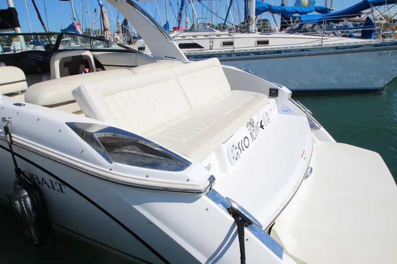 Slide: The Image of 2016 Cobalt R30 boat with white seating, docked in a marina. - 10