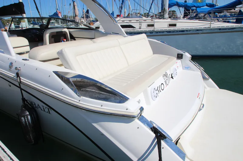 Slide: The Image of 2016 Cobalt R30 boat with white seating, docked in a marina. - 11