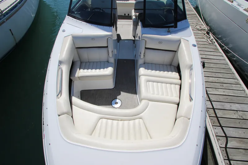 Slide: The Image of 2016 Cobalt R30 boat with spacious white seating, docked at marina. - 12