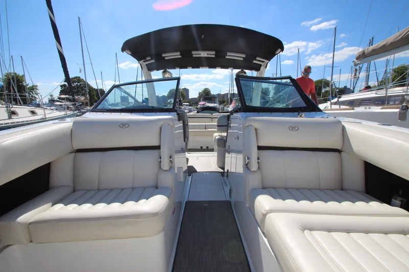 Slide: The Image of 2016 Cobalt R30 boat interior with white seating and open deck, docked at marina. - 15