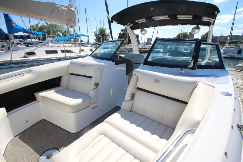 Slide: The Image of 2016 Cobalt R30 boat interior with white seating, docked at a marina. - 17