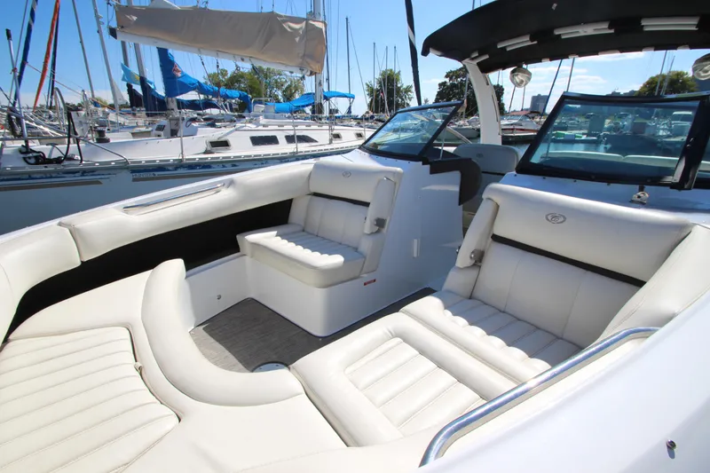 Slide: The Image of 2016 Cobalt R30 boat interior with white seating, docked at marina. - 18