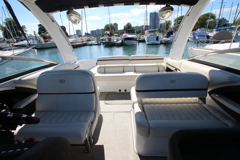 Slide: The Image of Luxurious 2016 Cobalt R30 boat interior with white seating, docked at a marina. - 22
