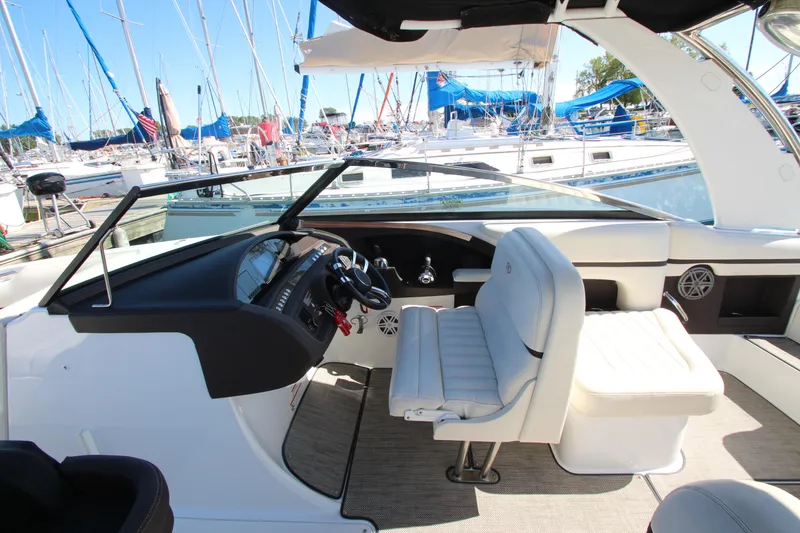 Slide: The Image of 2016 Cobalt R30 boat interior with helm and seating, docked at marina. - 26