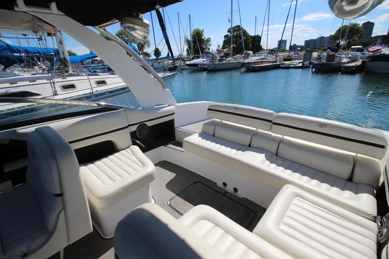 Slide: The Image of Luxurious 2016 Cobalt R30 boat interior with white seating, docked at a marina. - 27