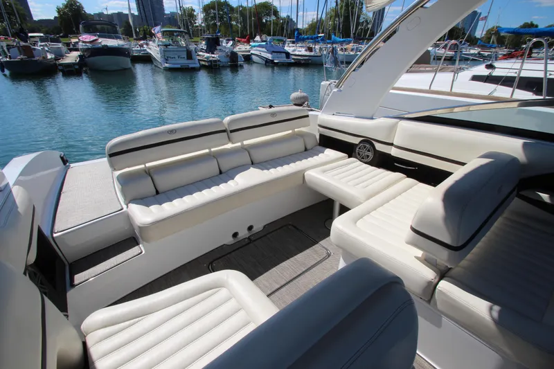 Slide: The Image of Luxurious 2016 Cobalt R30 boat interior with white seating, docked in a marina. - 30