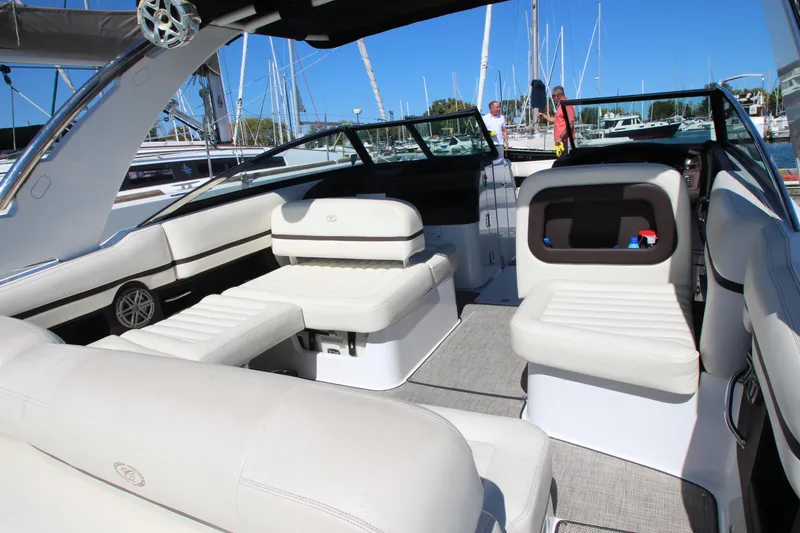 Slide: The Image of 2016 Cobalt R30 boat interior with white seating, docked at a marina. - 33