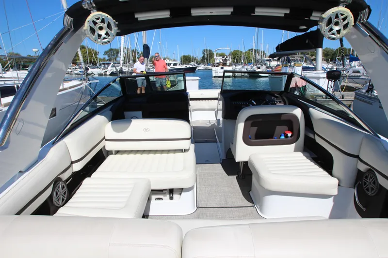 Slide: The Image of 2016 Cobalt R30 boat interior with white seating, docked at marina. - 37