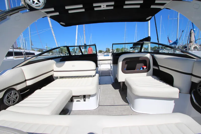 Slide: The Image of 2016 Cobalt R30 boat interior with white seating and open deck, docked at marina. - 38