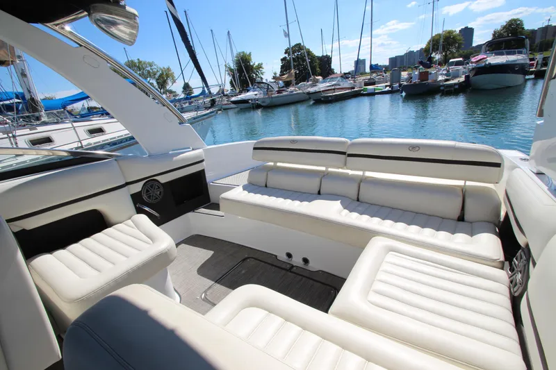 Slide: The Image of Luxurious 2016 Cobalt R30 boat interior with white seating, docked at a marina. - 40