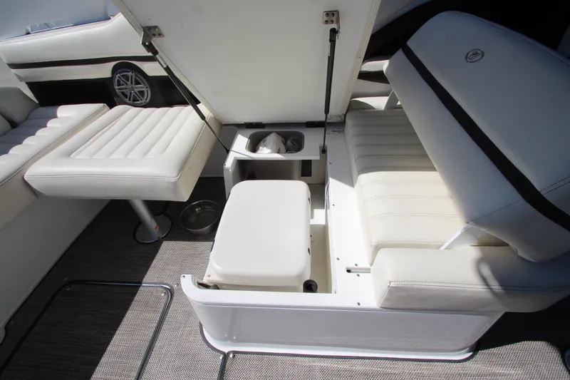 Slide: The Image of 2016 Cobalt R30 boat interior with white seating and storage compartments. - 43