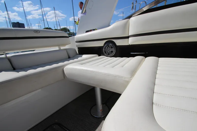 Slide: The Image of 2016 Cobalt R30 boat interior with white leather seating and open deck. - 45