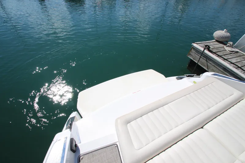 Slide: The Image of 2016 Cobalt R30 boat docked on calm water with sun reflecting. - 5