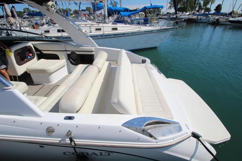 Slide: The Image of 2016 Cobalt R30 boat with white seating, docked in a marina. - 9