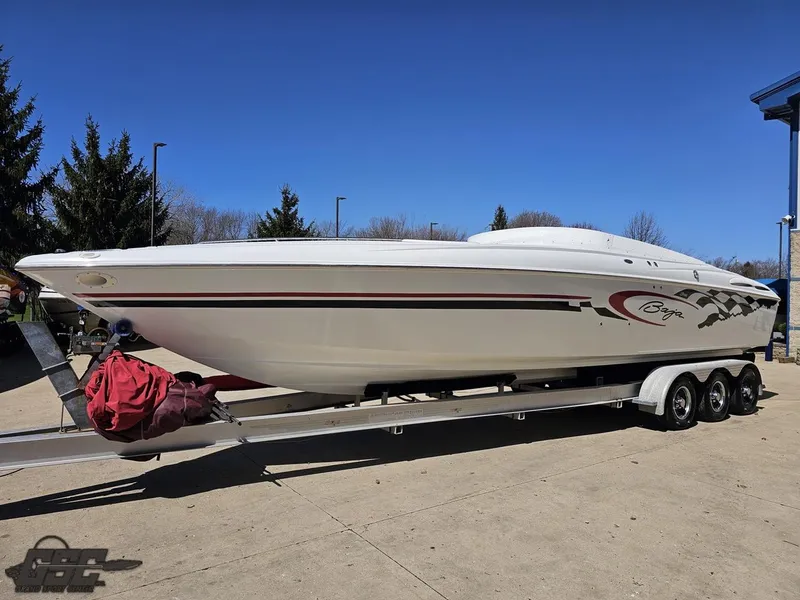 Slide: The Image of 2002 Baja 342 speedboat on trailer, parked outdoors under clear blue sky. - 14