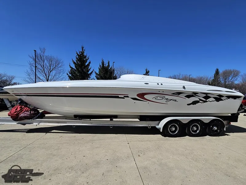 Slide: The Image of 2002 Baja 342 speedboat on trailer, white with red and black accents, parked outdoors. - 17