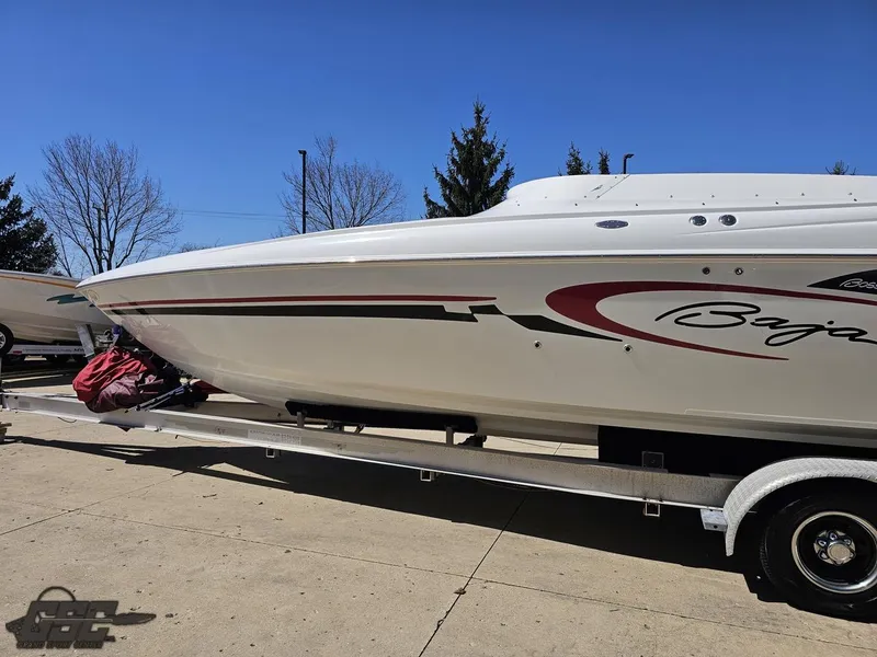 Slide: The Image of 2002 Baja 342 speedboat on trailer, white with red accents, parked outdoors. - 19