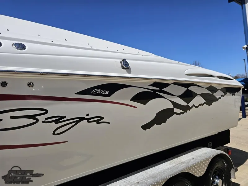 Slide: The Image of 2002 Baja 342 boat with checkered flag design and "Boss" logo on the side. - 22