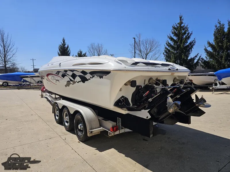 Slide: The Image of 2002 Baja 342 speedboat on a trailer, parked outdoors, with a sleek white design. - 26