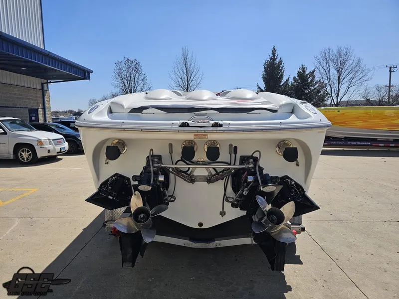 Slide: The Image of Rear view of a 2002 Baja 342 boat with dual propellers in a parking lot. - 27