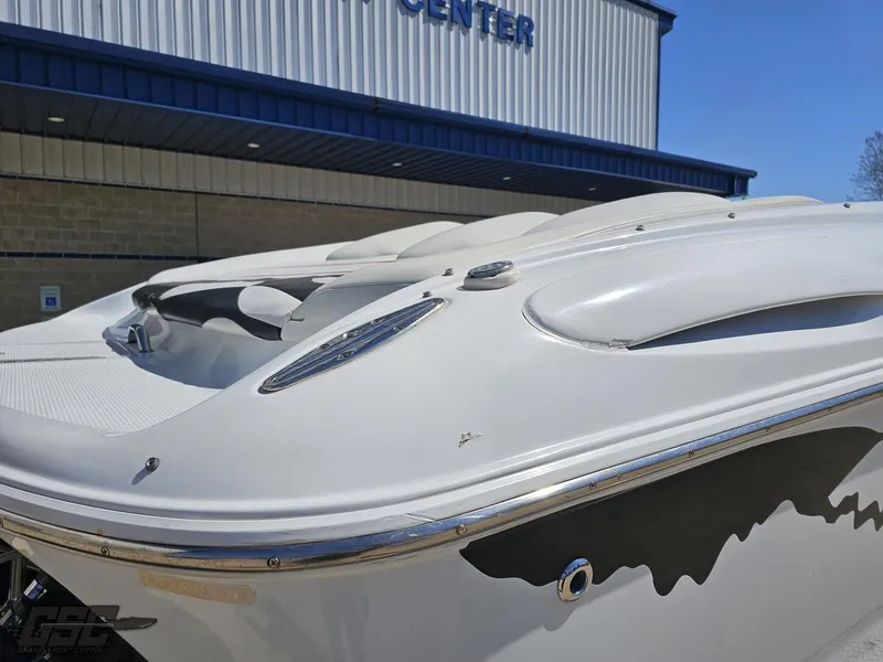 Slide: The Image of 2002 Baja 342 boat exterior near a building, showcasing sleek design and detailing. - 31