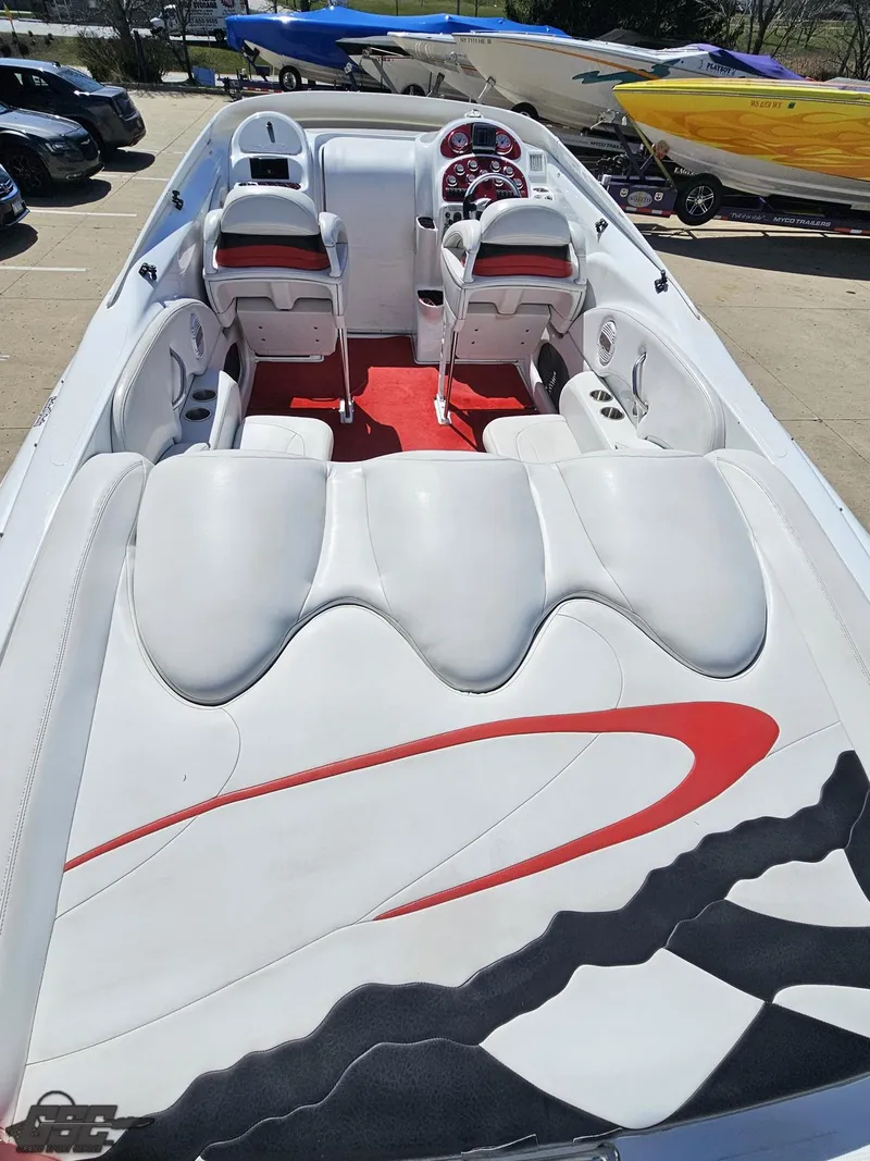 Slide: The Image of 2002 Baja 342 boat interior with white and red seating, sleek design, and modern dashboard. - 36