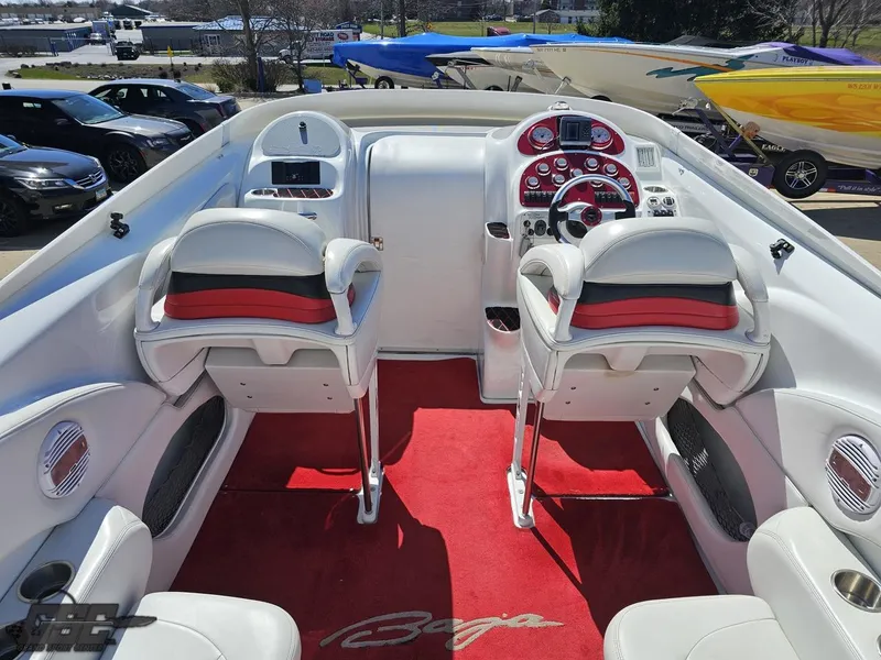 Slide: The Image of 2002 Baja 342 boat interior with red and white seating, dashboard, and steering wheel. - 45